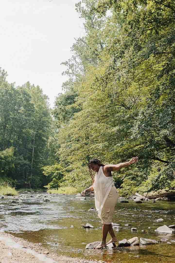 Charika White balancing on creek stones in Maryland, the steadiness affordable therapy brings adults in DC and Maryland