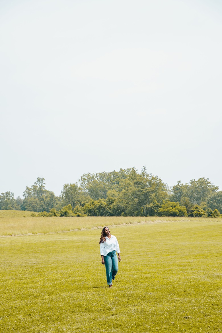 Charika White walking through an open Maryland field, room to breathe through therapy for Baltimore clients