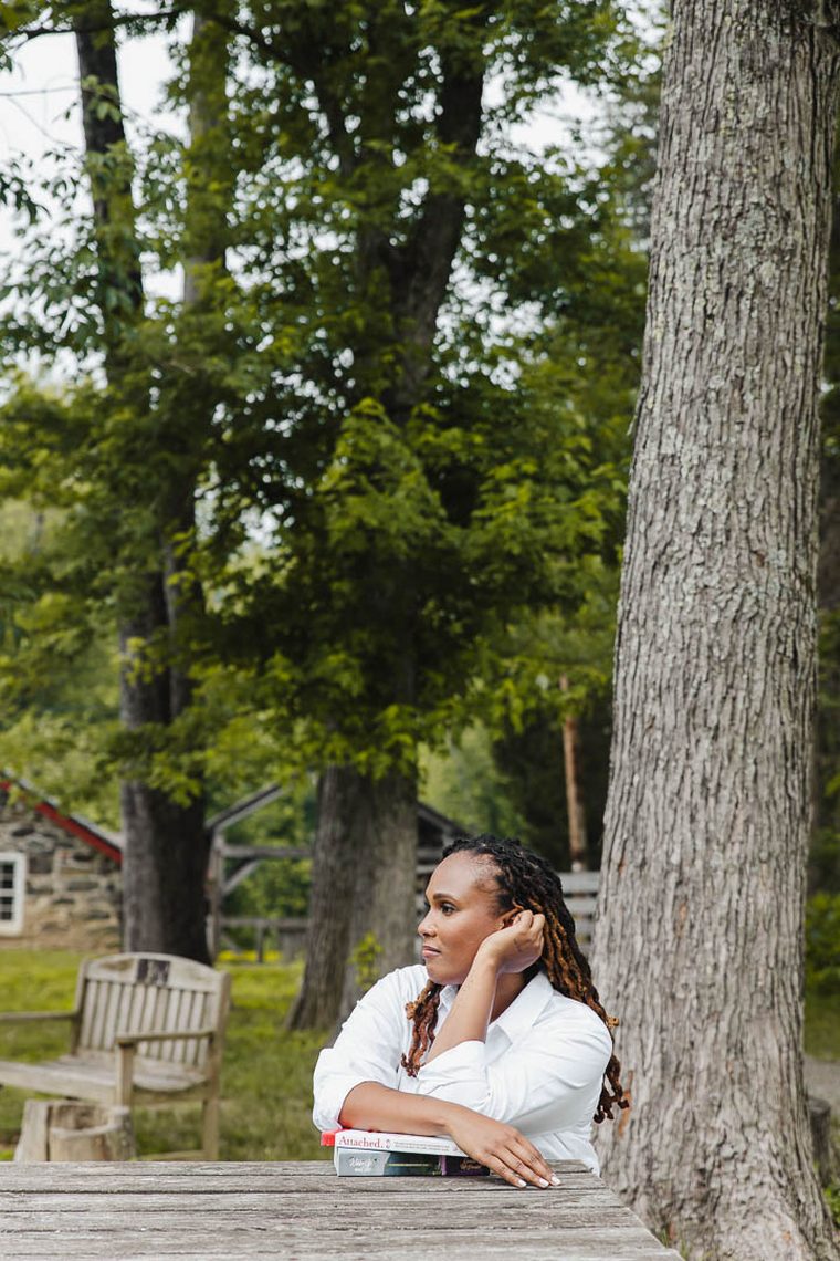 Charika White resting against a tree, licensed clinical social worker providing CBT in Washington DC