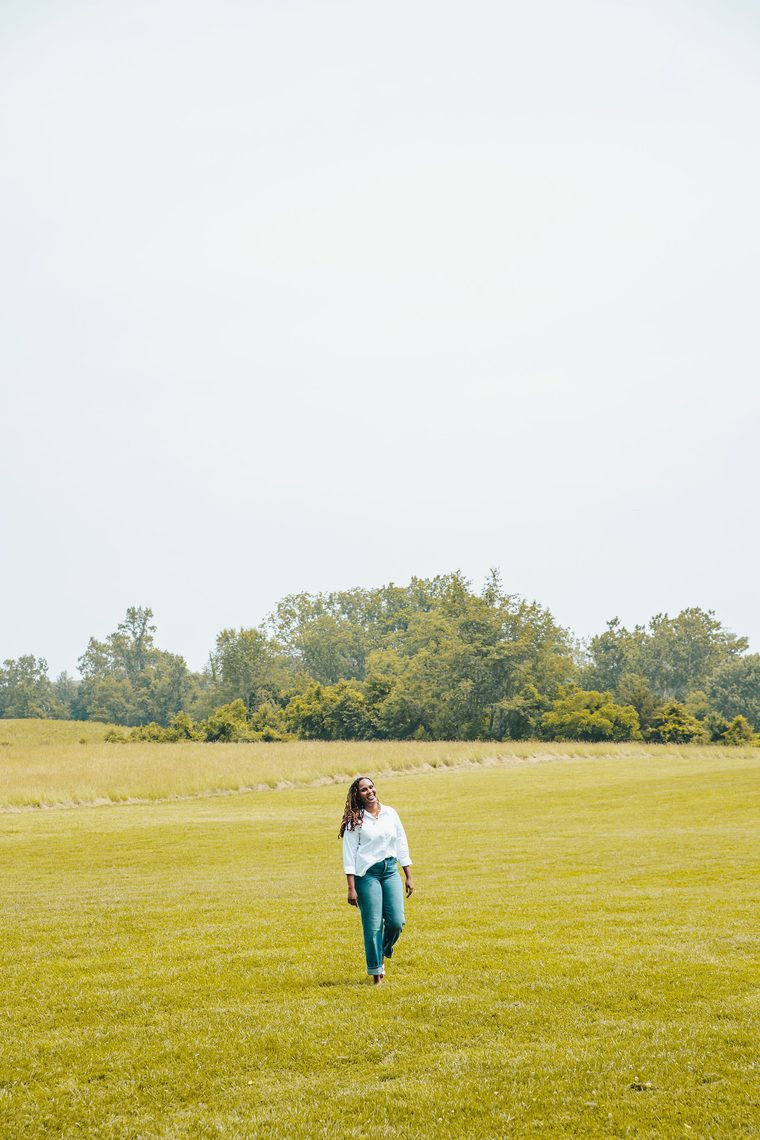 Charika White walking across an open field, employee burnout consulting for DC and Maryland teams
