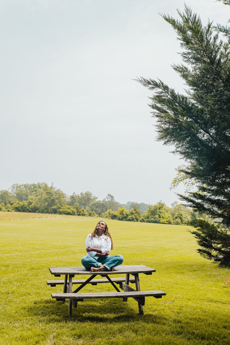 Charika White seated on a picnic table looking up at the Maryland sky, the hope behind the Green Bottle Method waitlist for DC therapy