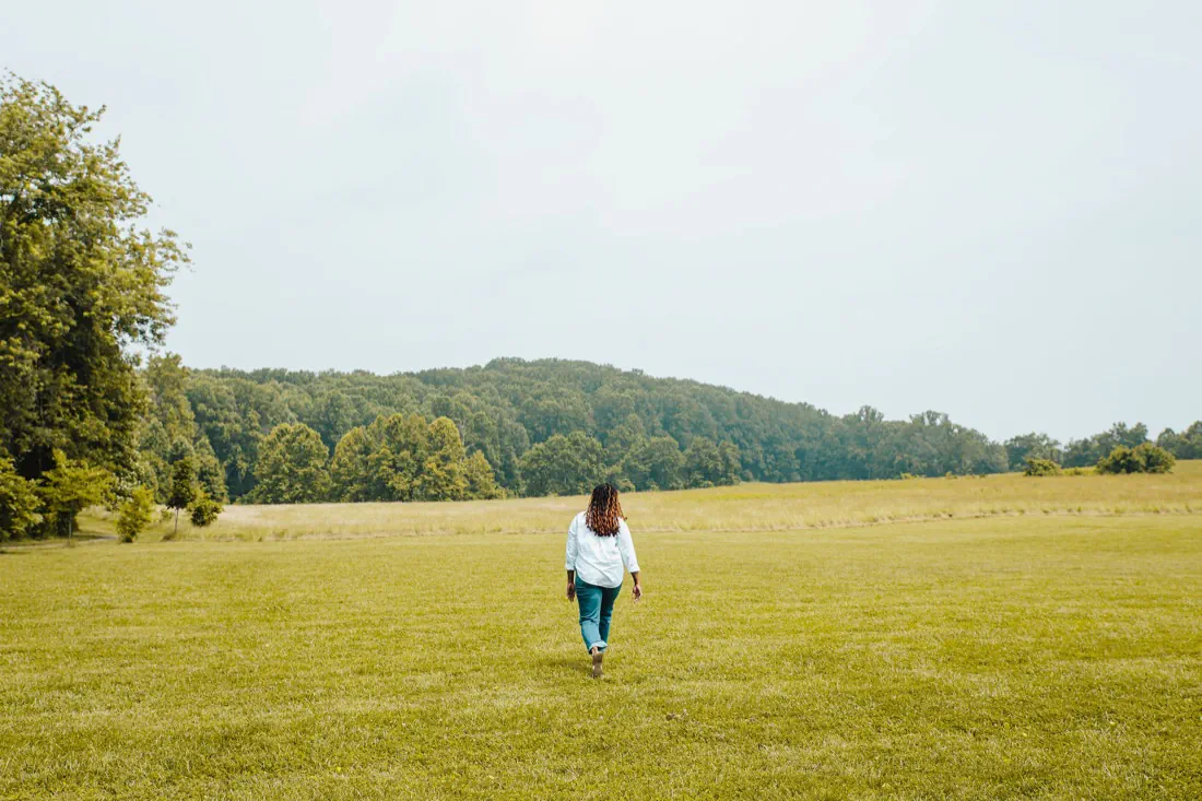 Charika White walking across an open Maryland field, the path forward after an immigration psychological evaluation supports your case