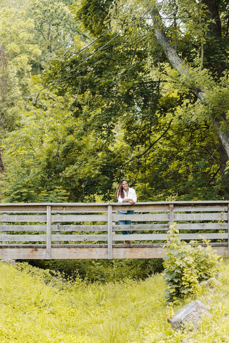 Charika White on a wooden footbridge, leadership development for culture change across Maryland and DC