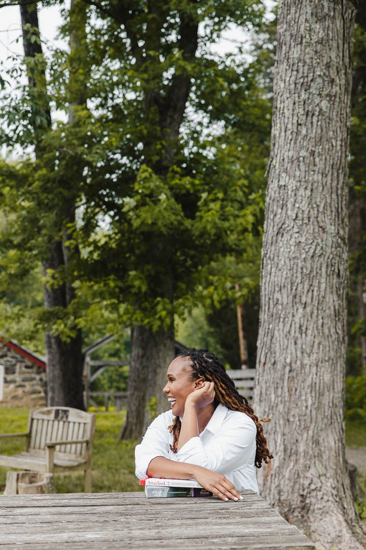Charika White resting against a tree, private telehealth therapy for queer and trans adults in Washington DC