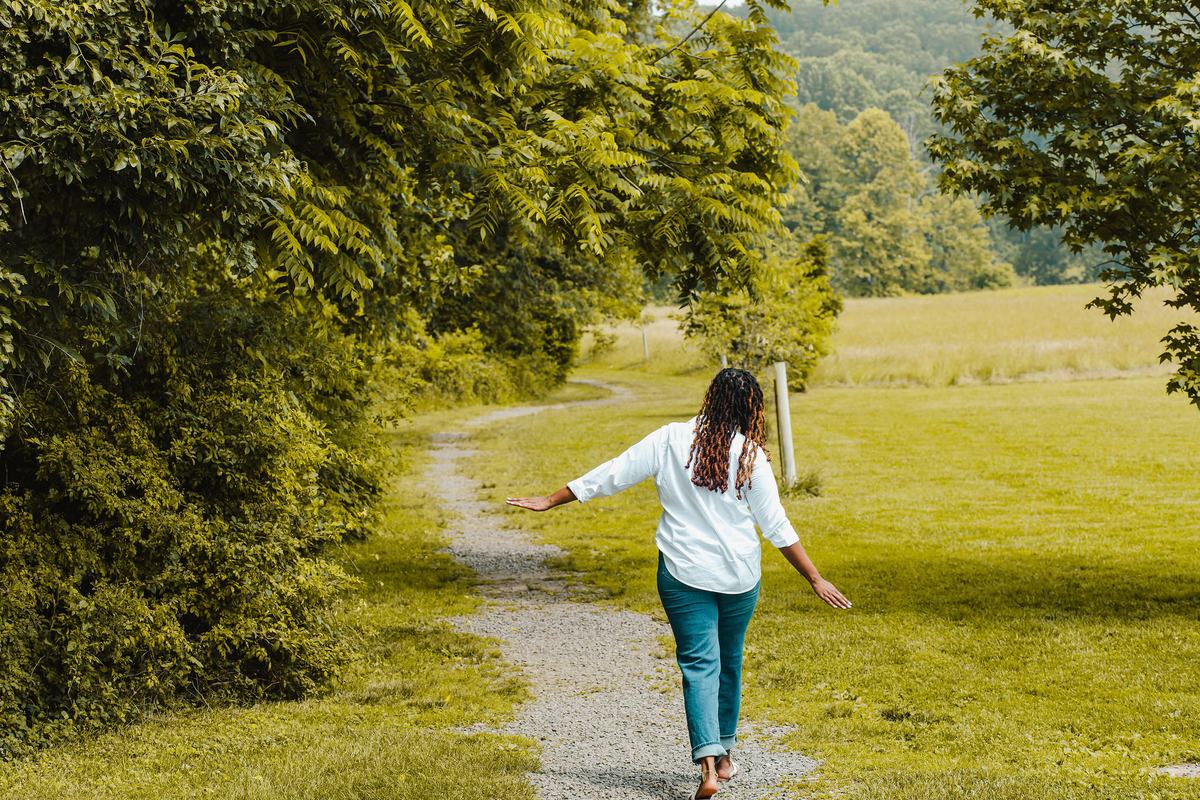 Charika White walking an open path through a field, therapy at your own pace for LGBTQ adults in Washington DC