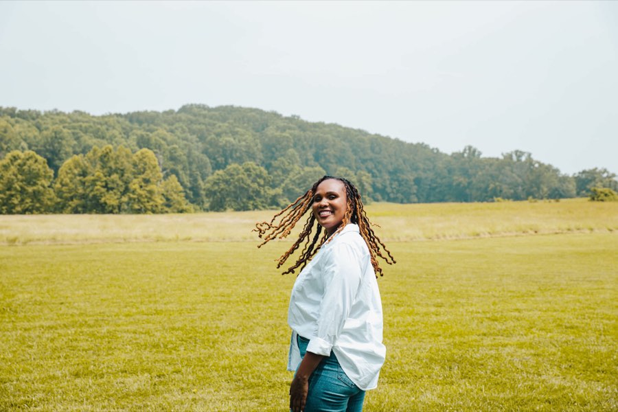 Charika White laughing in an open Maryland field, the ease self pay mental health services bring DC and Maryland clients