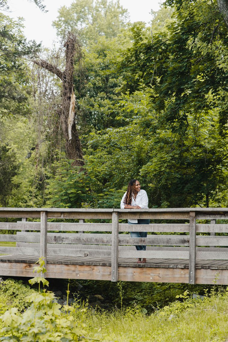 Charika White on a wooden footbridge, staff retention consulting for Washington DC and Maryland employers