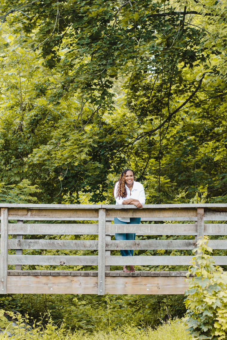 Charika White standing on a wooden footbridge, the roadmap that follows a therapy intensive in Maryland and DC